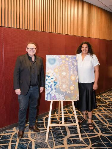James Cudmore from NMG with Tywana Caldwell and artwork Reconcile Connection. Picture supplied